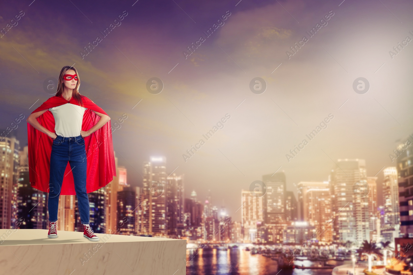 Image of Superhero, motivation and power. Woman in cape and mask on high building in city