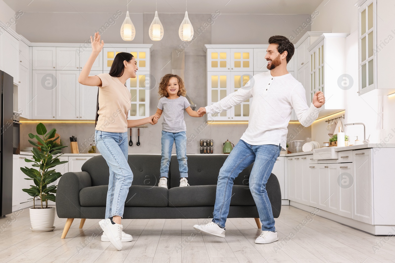 Photo of Happy family dancing and having fun at home, low angle view