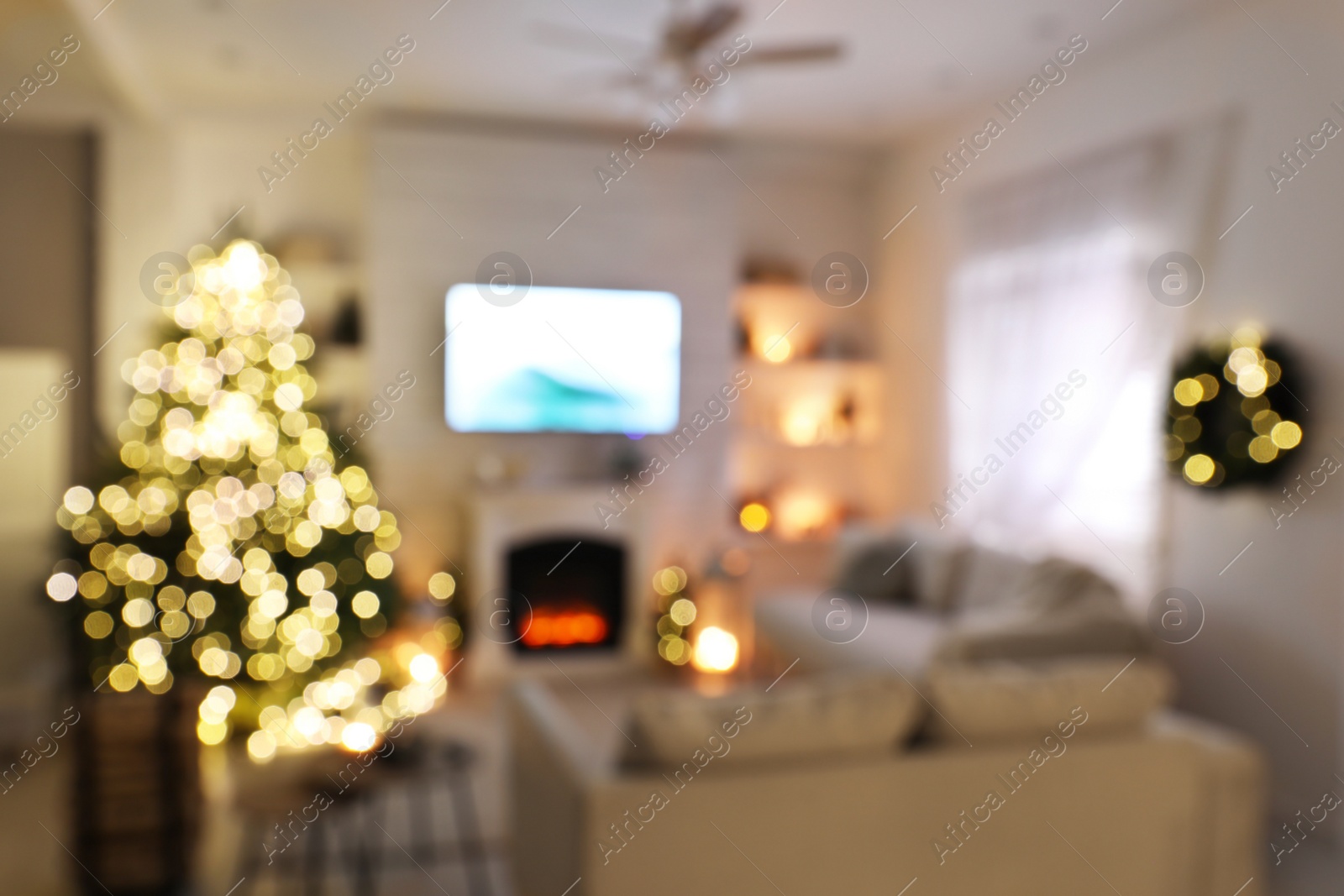 Photo of Blurred view of stylish living room interior with decorated Christmas tree and TV set