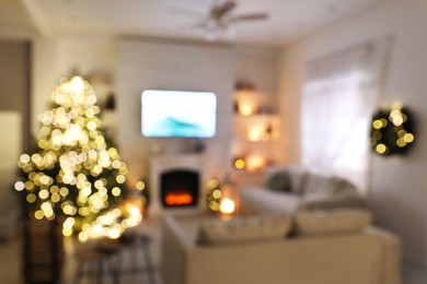 Photo of Blurred view of stylish living room interior with decorated Christmas tree and TV set