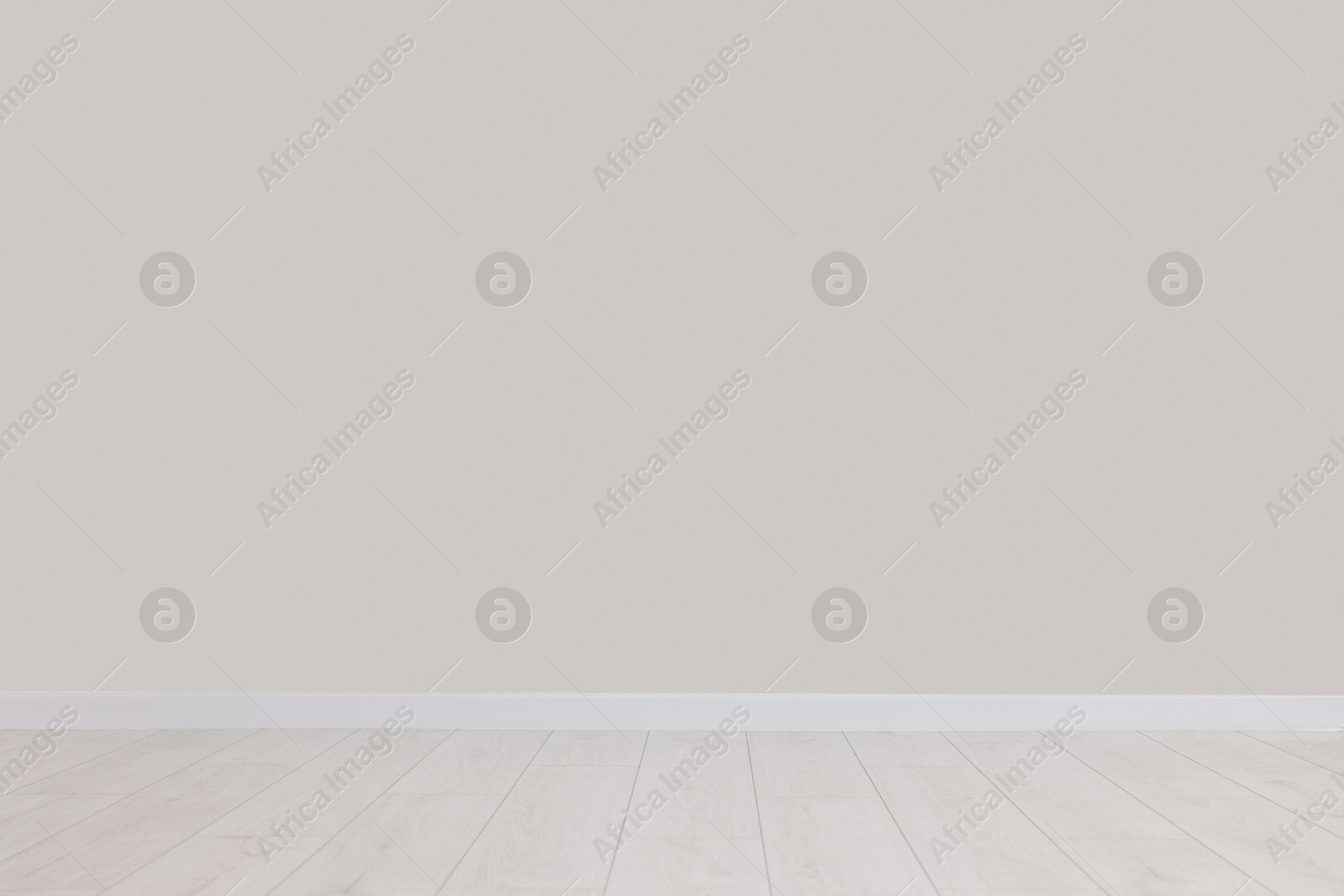 Photo of Empty room with white wall and wooden floor