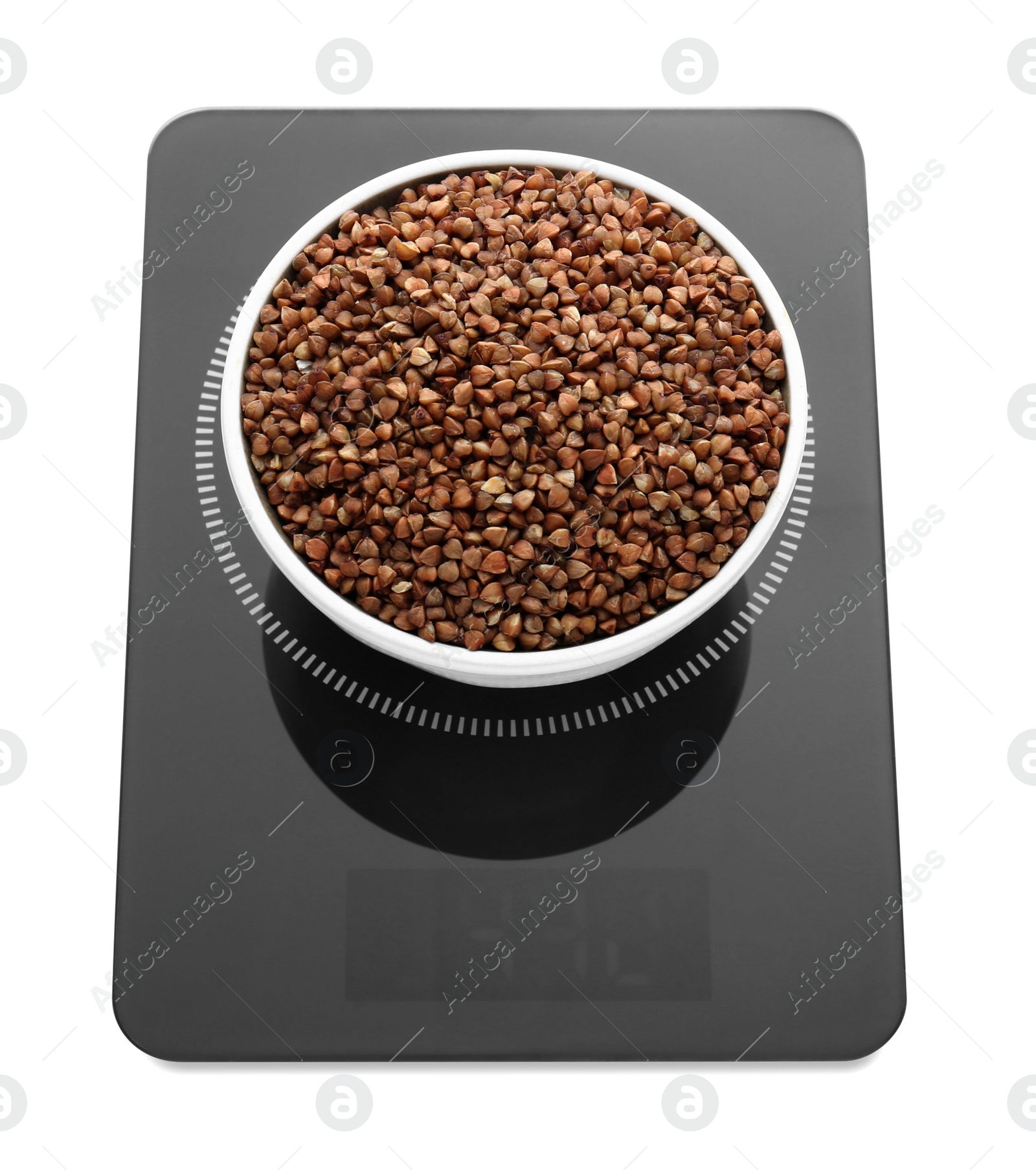 Photo of Modern kitchen scale with bowl of raw buckwheat isolated on white