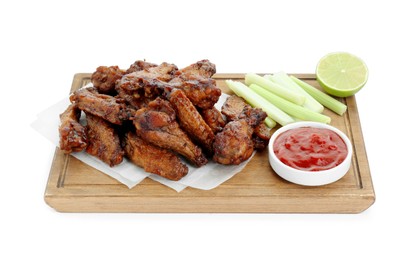 Photo of Tasty chicken wings served with ketchup, cut celery stalks and lime isolated on white