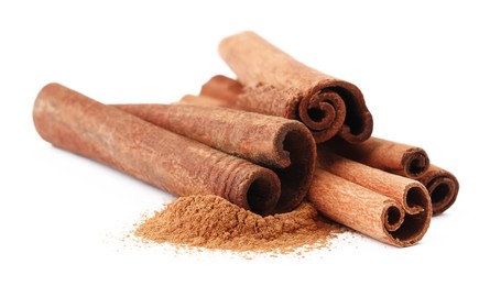 Photo of Dry aromatic cinnamon sticks and powder isolated on white