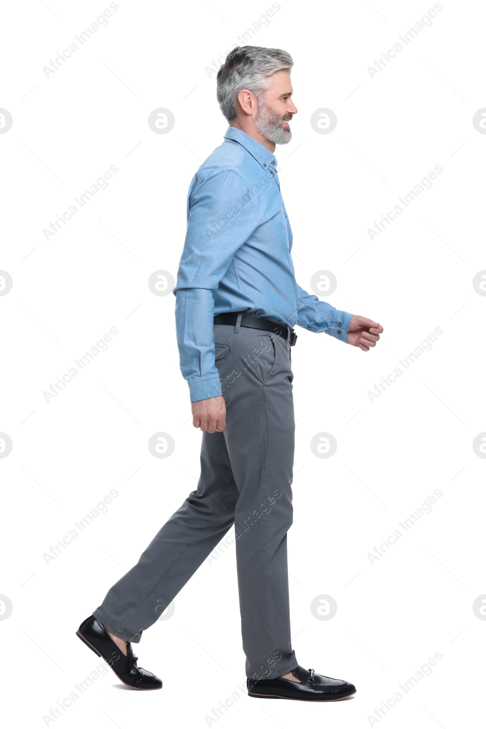 Photo of Mature businessman in stylish clothes posing on white background