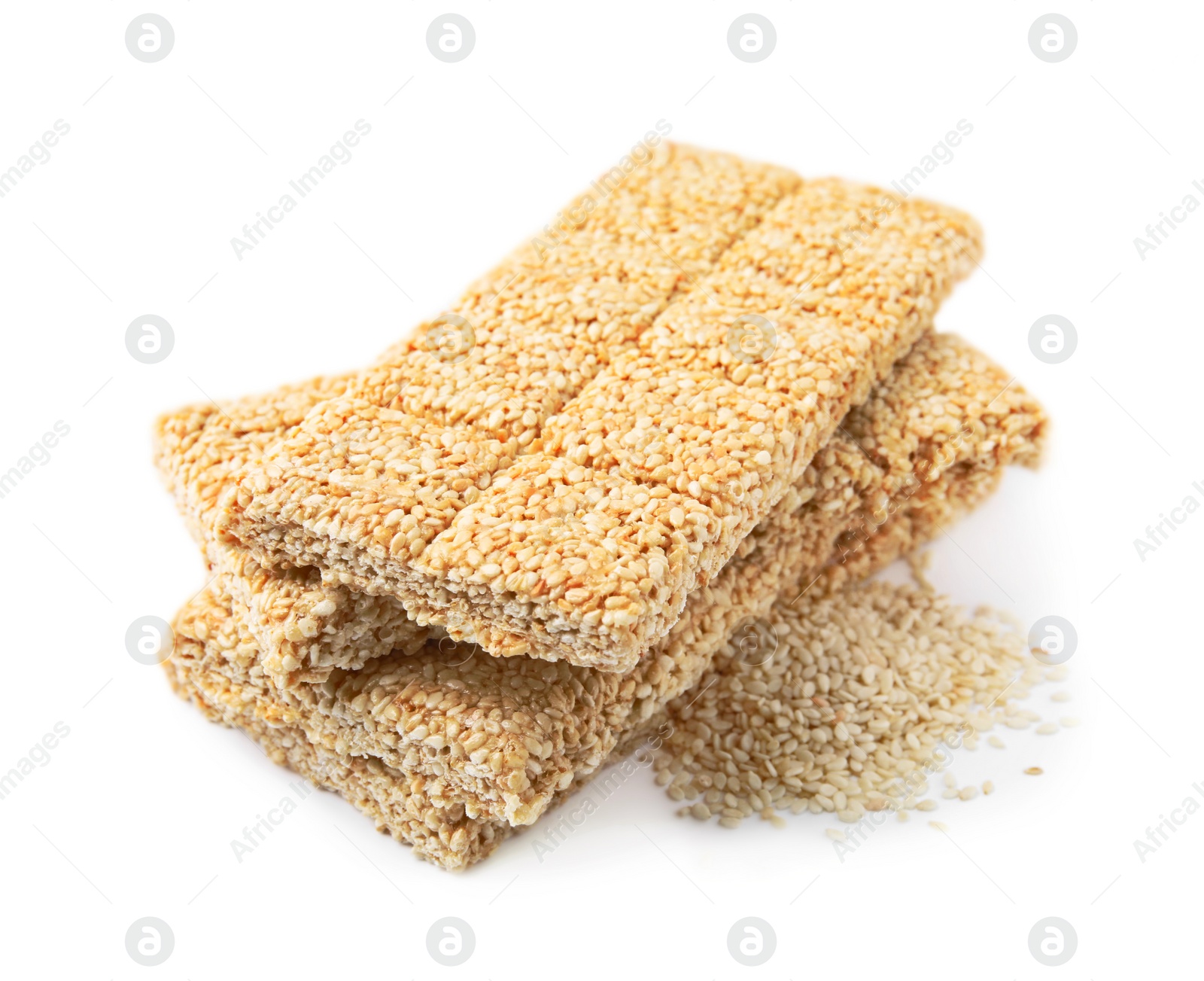 Photo of Delicious sweet kozinaki bars and sesame seeds on white background