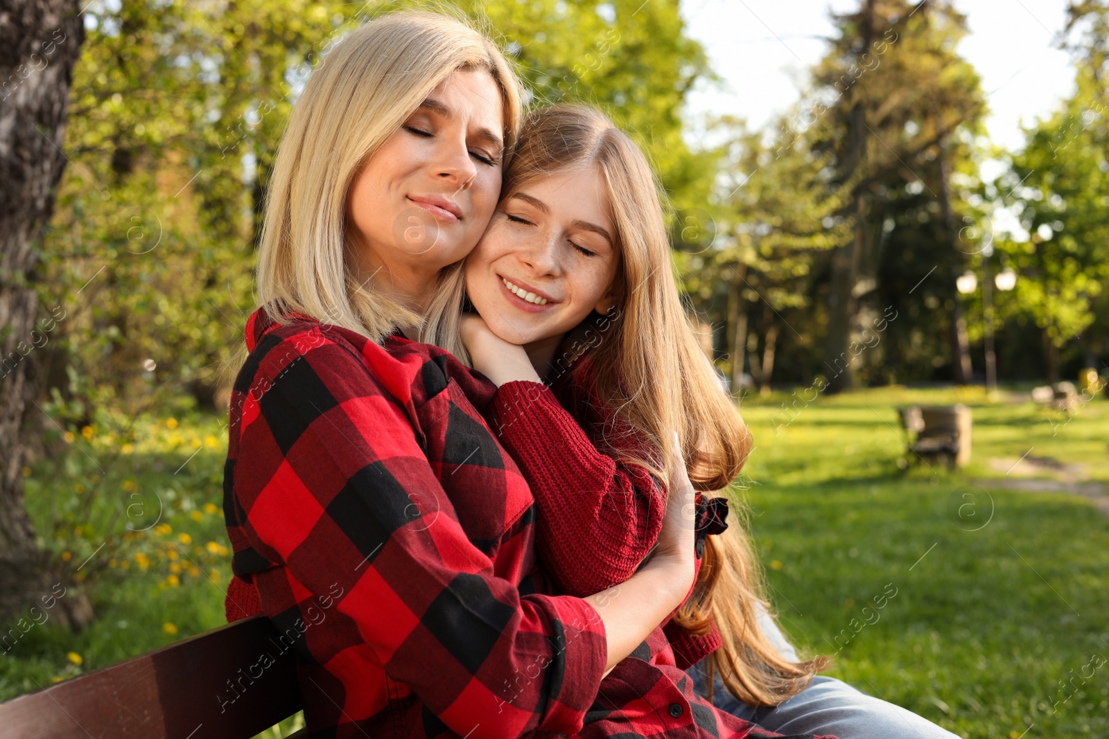 Photo of Happy mother with her daughter spending time together in park on sunny day