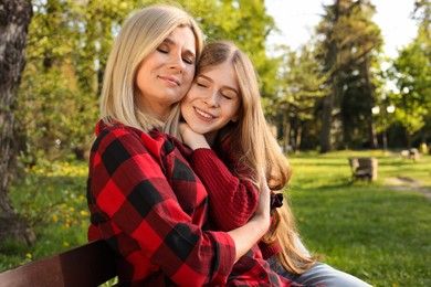 Photo of Happy mother with her daughter spending time together in park on sunny day