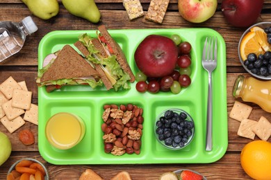 Photo of Flat lay composition with serving tray, tasty healthy food on wooden table. School dinner