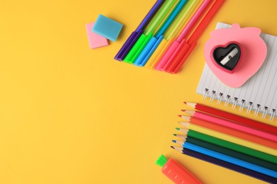 Photo of Flat lay composition with different school stationery on yellow background, space for text. Back to school