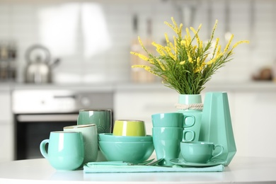 Kitchen utensils in different mint color shades on table