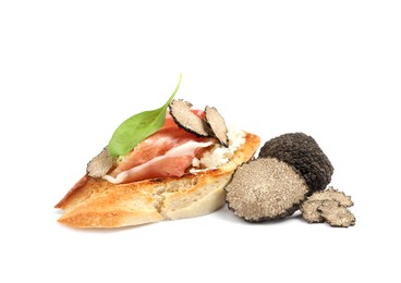 Tasty bruschetta with prosciutto and truffle on white background