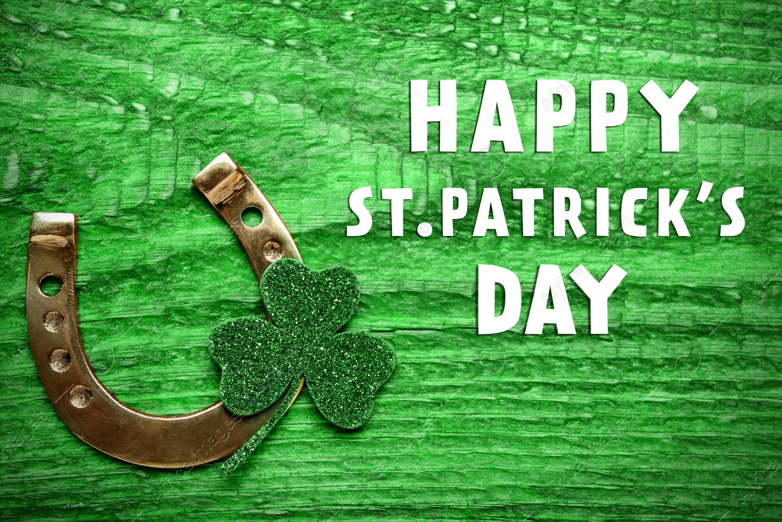 Image of Happy St. Patrick's Day. Golden horseshoe and decorative clover leaf on green wooden table, flat lay