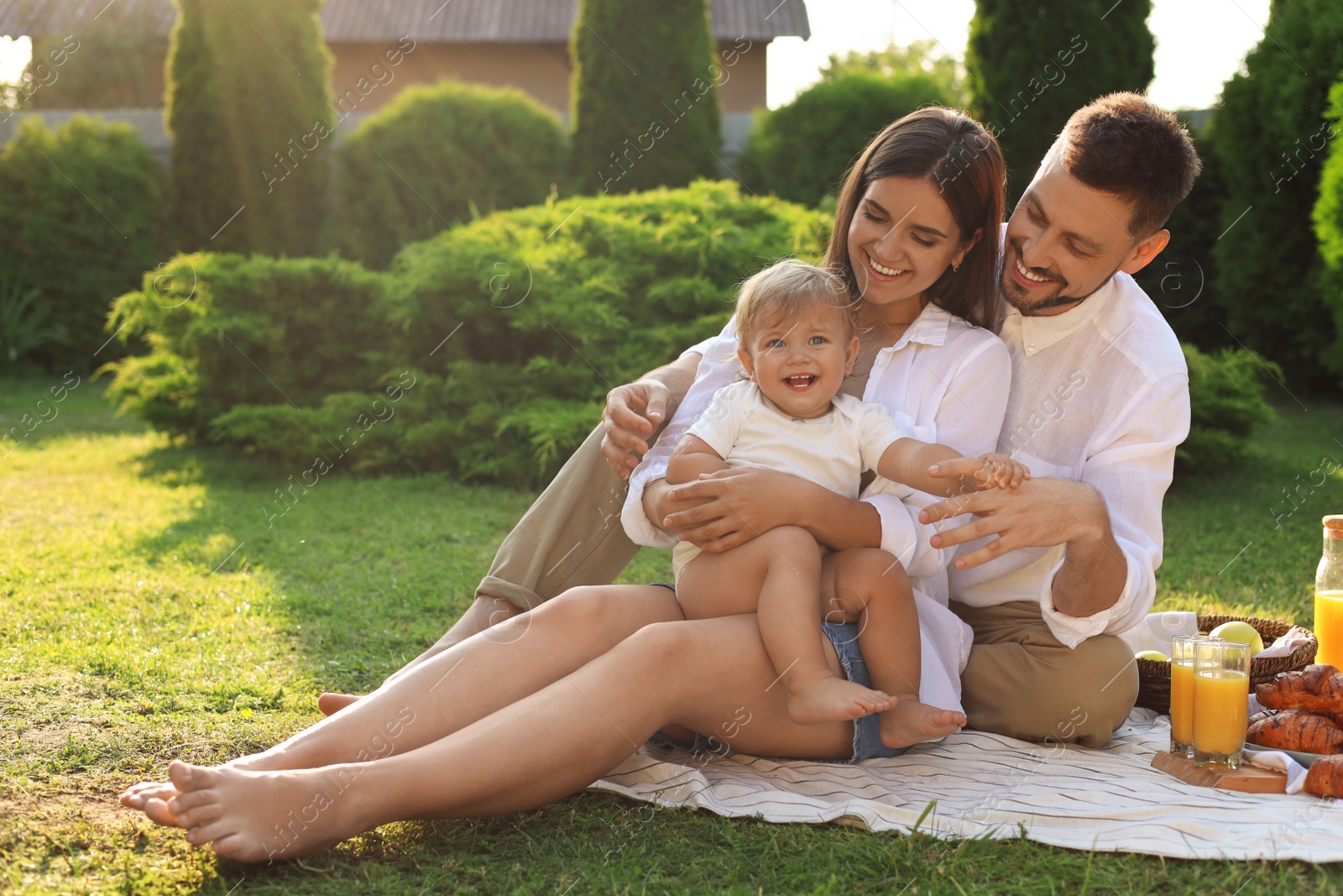 Photo of Happy family having picnic in garden on sunny day