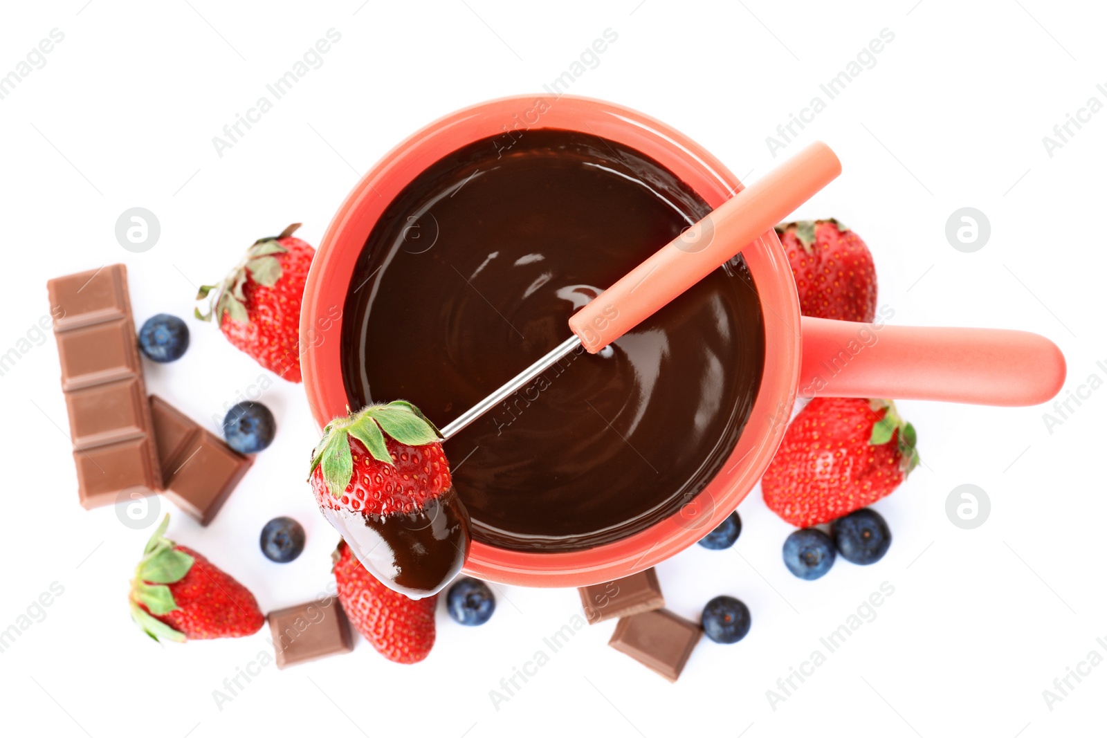 Photo of Fondue pot with dark chocolate and berries on white background, top view