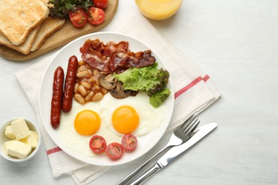 Delicious breakfast with sunny side up eggs served on white table, flat lay