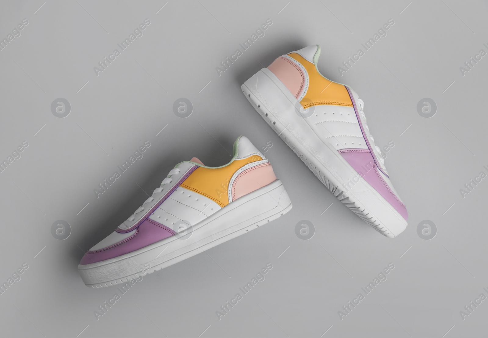 Photo of Pair of comfortable sports shoes on grey background, flat lay