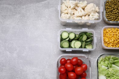 Photo of Glass and plastic containers with different fresh products on light grey table, flat lay. Space for text