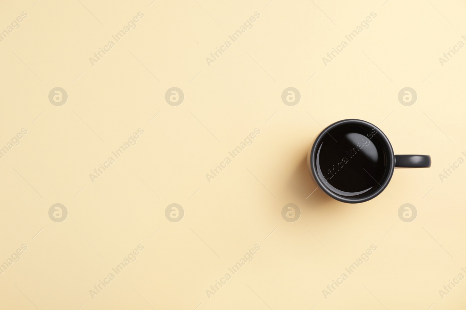 Photo of Ceramic cup with hot aromatic coffee on color background, top view