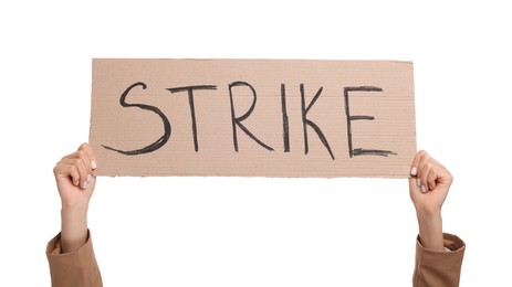 Woman holding cardboard banner with word Strike on white background, closeup
