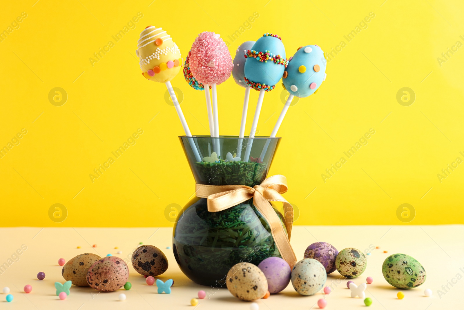 Photo of Delicious sweet cake pops on table. Easter holiday