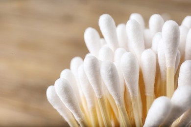 Photo of Many cotton buds on blurred background, closeup