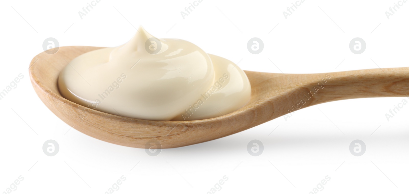 Photo of Natural yogurt in wooden spoon isolated on white