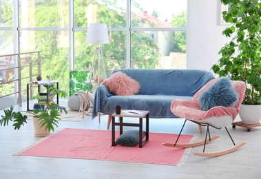 Photo of Elegant living room interior with rocking chair and cozy sofa