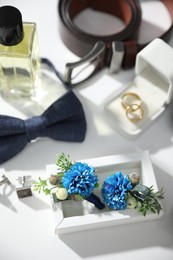 Wedding stuff. Composition with stylish boutonniere on white background, closeup