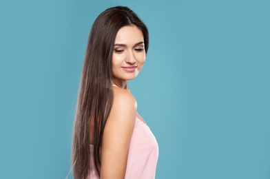 Portrait of beautiful model with gorgeous straight hair on color background