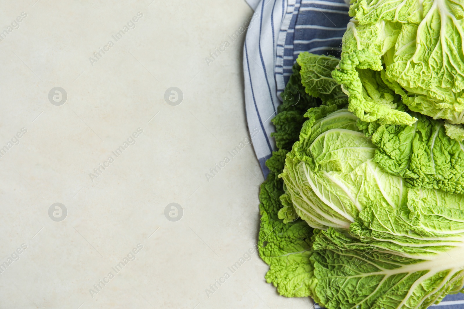 Photo of Fresh ripe Chinese cabbages on grey table, flat lay. Space for text