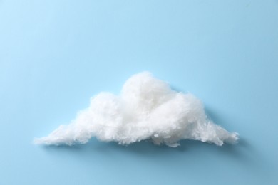 Photo of Cloud made of cotton on light blue background