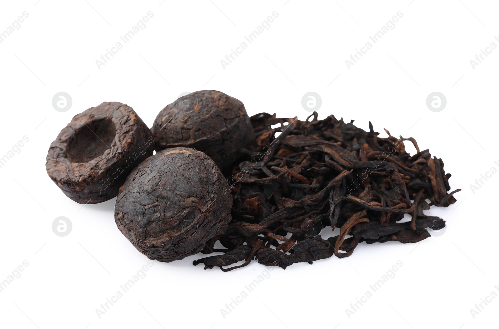 Photo of Cake shaped traditional Chinese pu-erh tea and leaves isolated on white