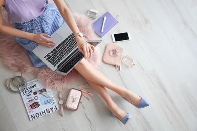 Photo of Female beauty blogger with laptop indoors, top view