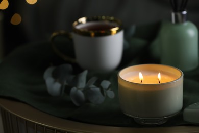 Photo of Beautiful burning candle on table. Space for text