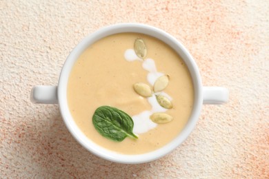 Photo of Healthy cream soup high in vegetable fats on color textured table, top view