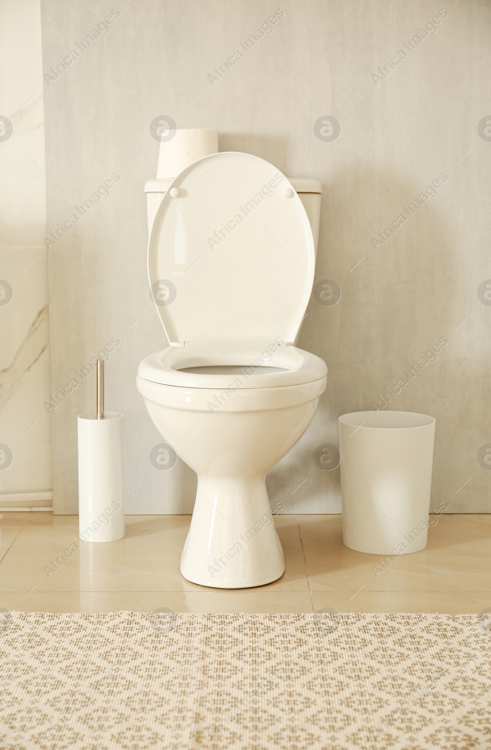 Photo of White toilet bowl in modern bathroom interior