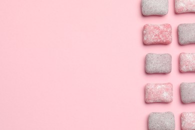 Tasty colorful bubble gums on pink background, flat lay. Space for text