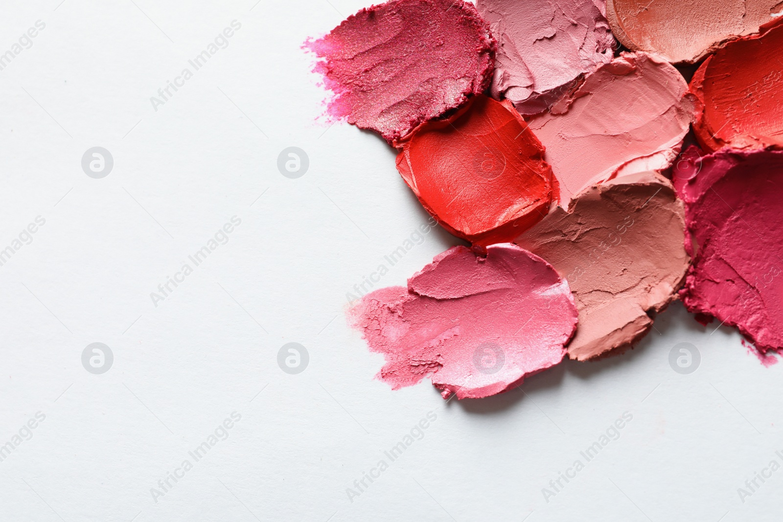 Photo of Collection of lipstick swatches on white background, top view