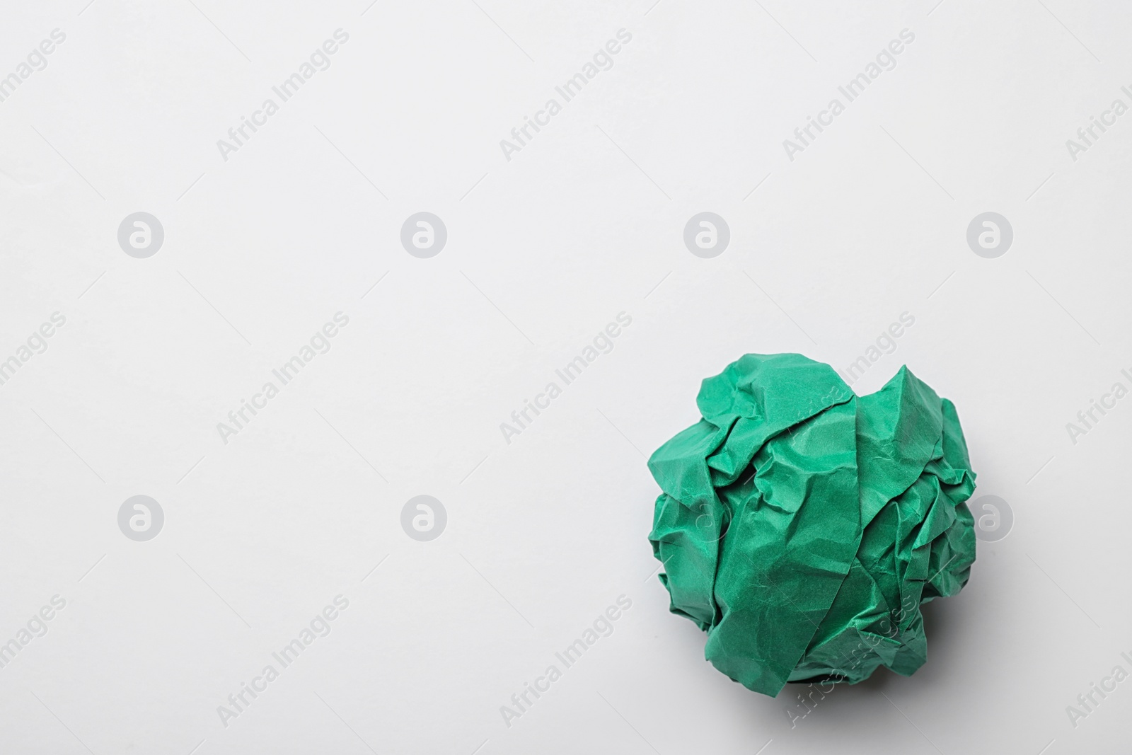 Photo of Colorful crumpled sheet of paper on white background, top view