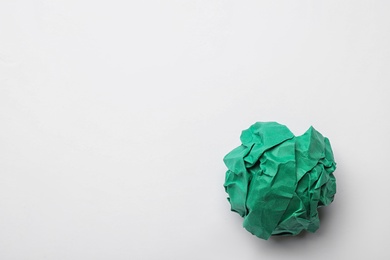Photo of Colorful crumpled sheet of paper on white background, top view