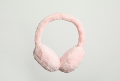 Photo of Fluffy earmuffs on white background. Stylish winter accessory