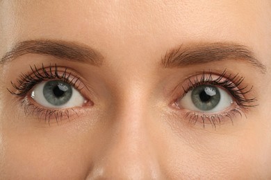 Photo of Woman with long eyelashes after mascara applying, closeup