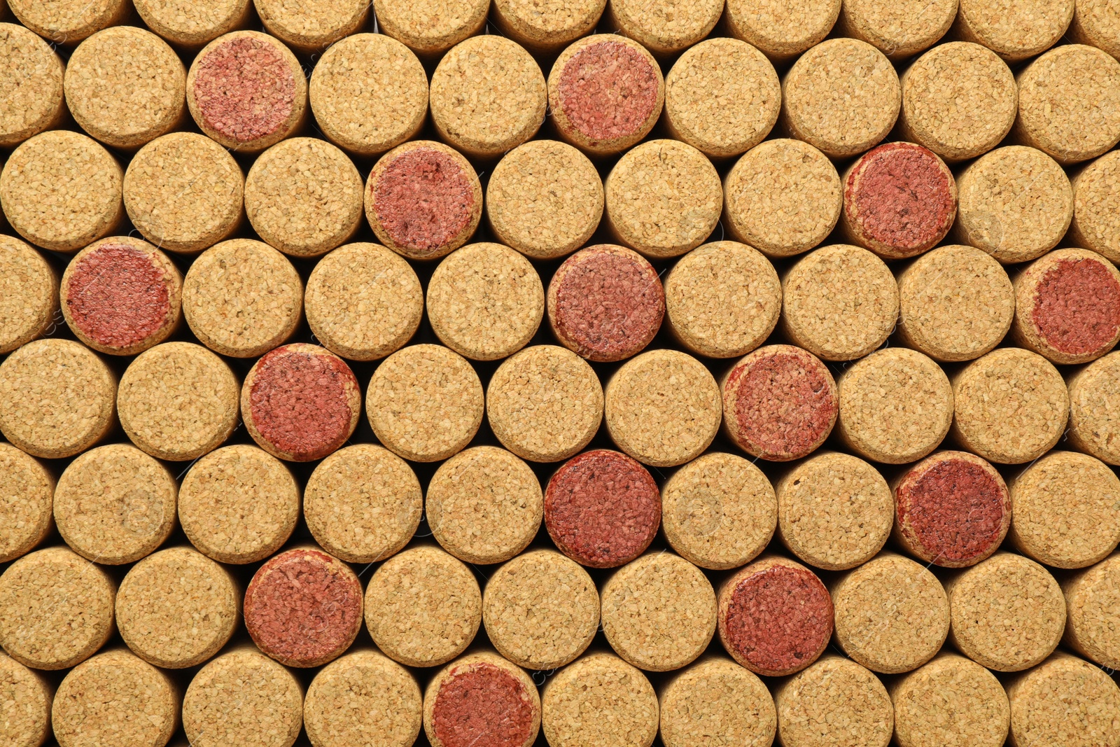 Photo of Many wine bottle corks as background, top view