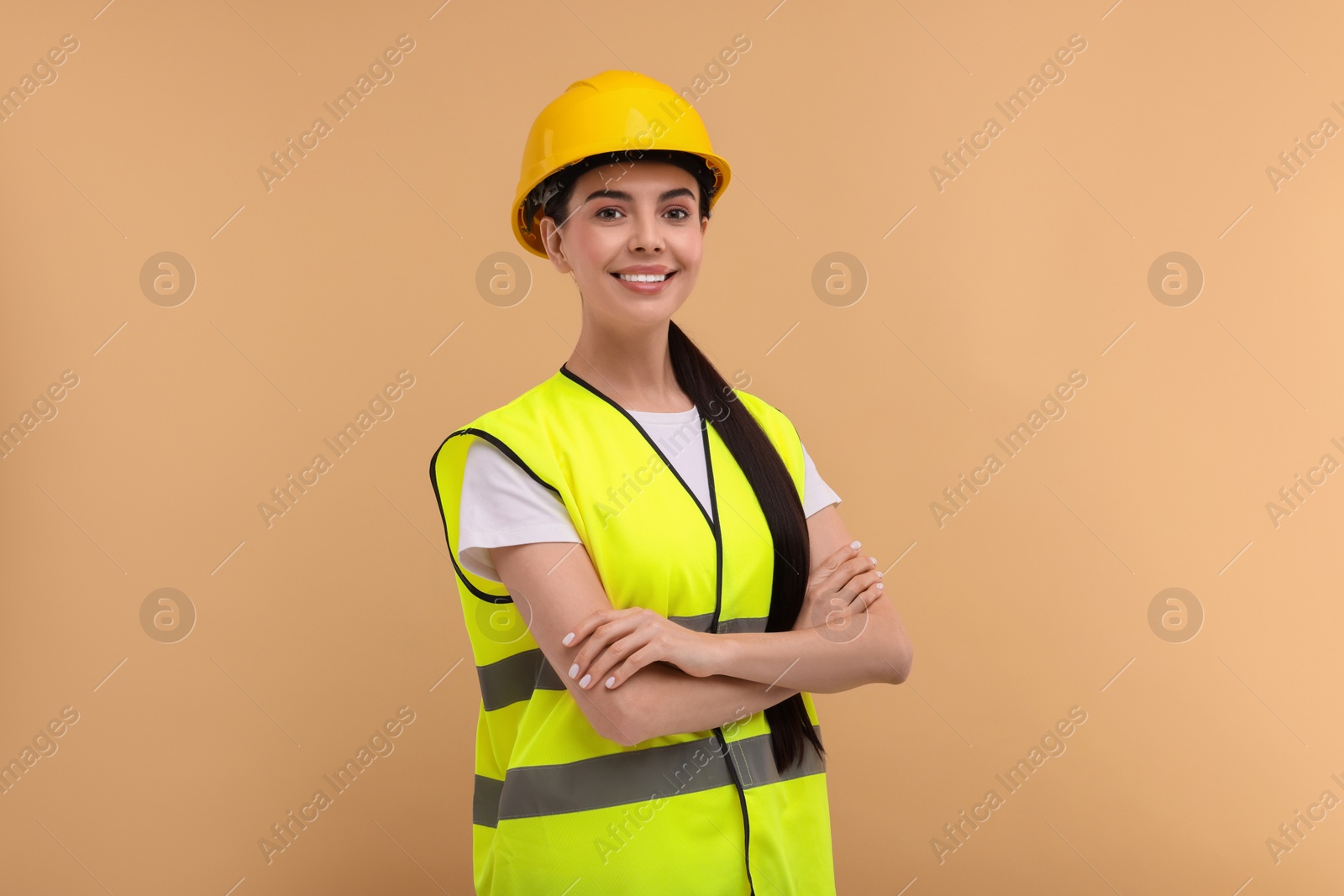 Photo of Engineer in hard hat on beige background