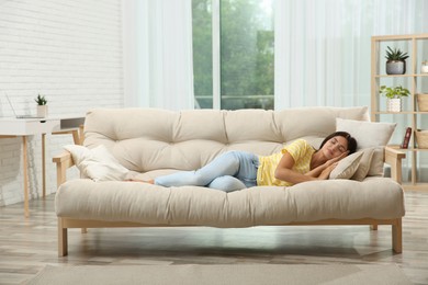 Photo of Young woman sleeping on sofa at home
