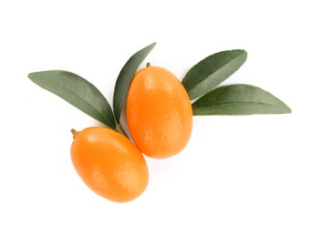 Photo of Fresh ripe kumquats with leaves on white background, top view. Exotic fruit