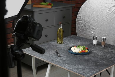 Composition with mozzarella salad on black table in professional photo studio. Food photography