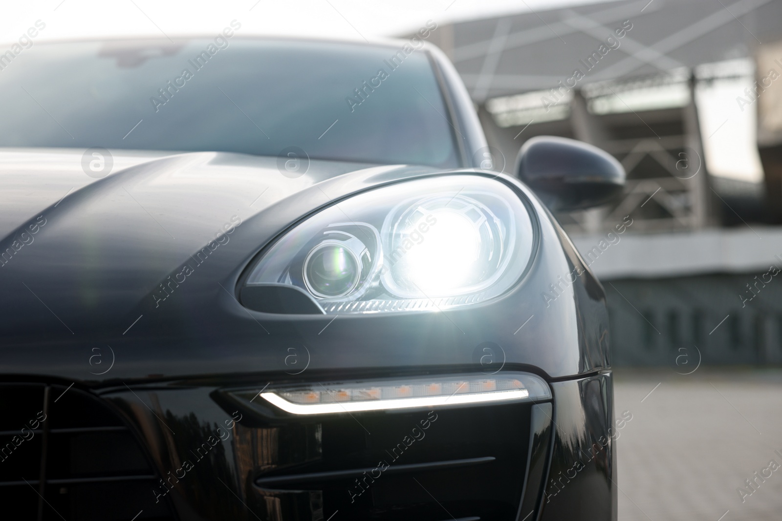 Photo of Modern black car parked outdoors, closeup view