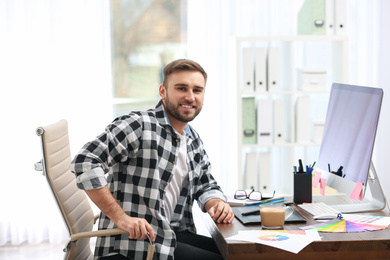 Male designer working at desk in office